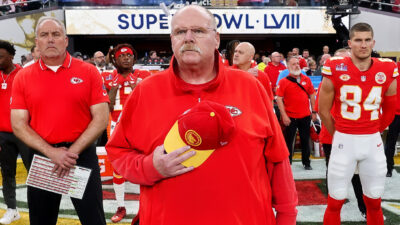 Andy Reid standing for the national anthem
