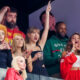 Taylor Swift with her hand in the air