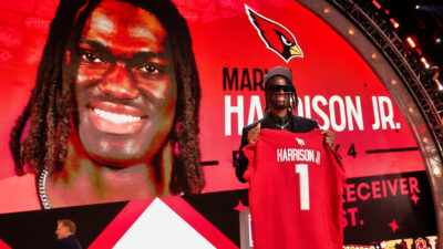 Marvin Harrison Jr. holding up his Cardinals jersey