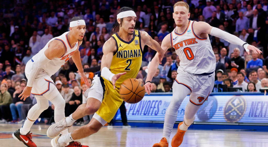 Andrew Nembhard drives past Donte DiVincenzo during Pacers-Knicks game.