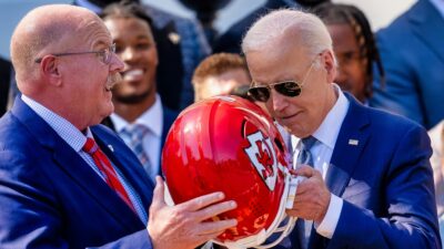 Joe Biden and Andy Reid holding Chiefs helmet