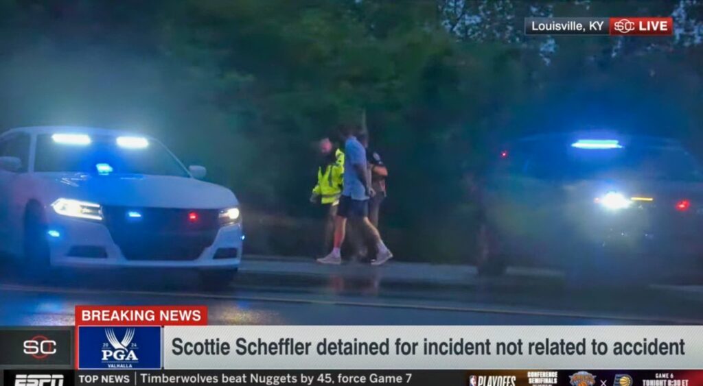 Scottie Scheffler in handcuffs being taken away by police.