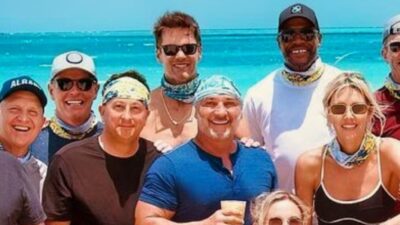 Tom Brady posing with NFL on Fox team on beach