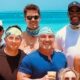 Tom Brady posing with NFL on Fox team on beach