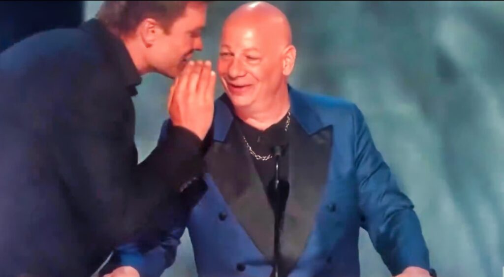 Tom Brady whispers something into Jeff Ross' ear during the Netflix Roast.