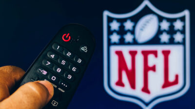 TV remote with NFL logo in the background