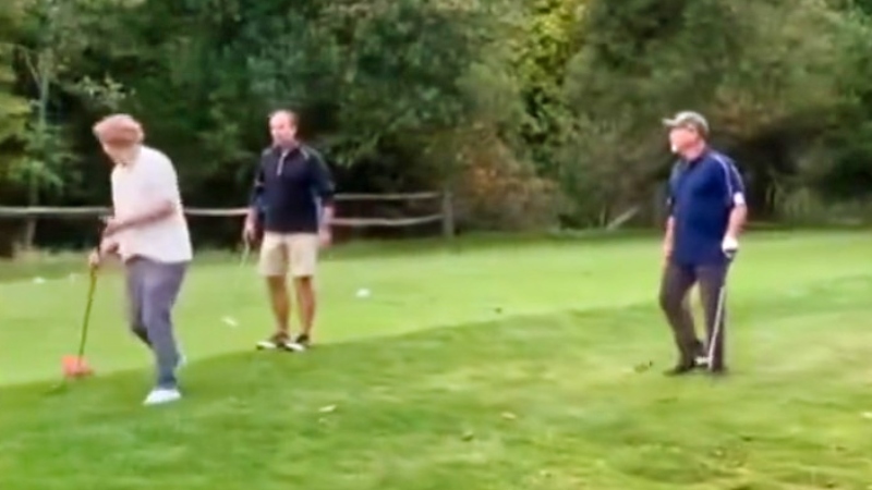 Three men in confrontation on golf course.