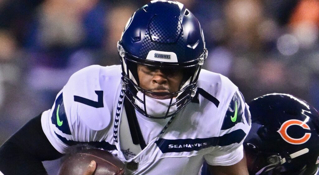 Geno Smith holding a football