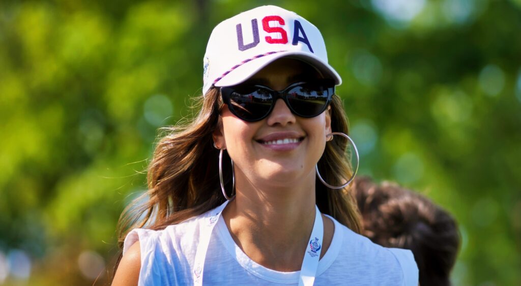 American actress Jessica Alba smiles as she walks the course.