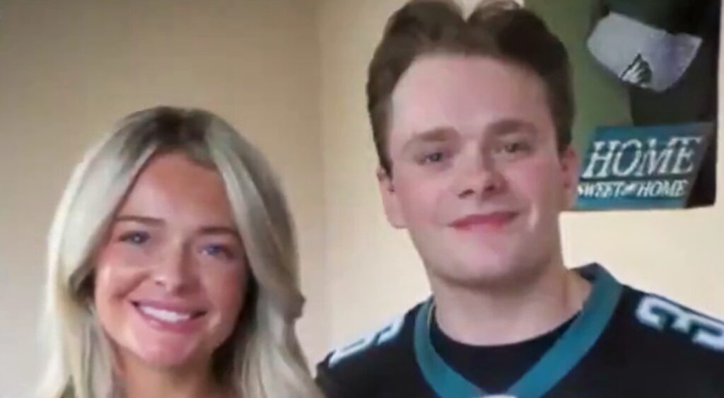 Billy Schmidt posing for photo with a female