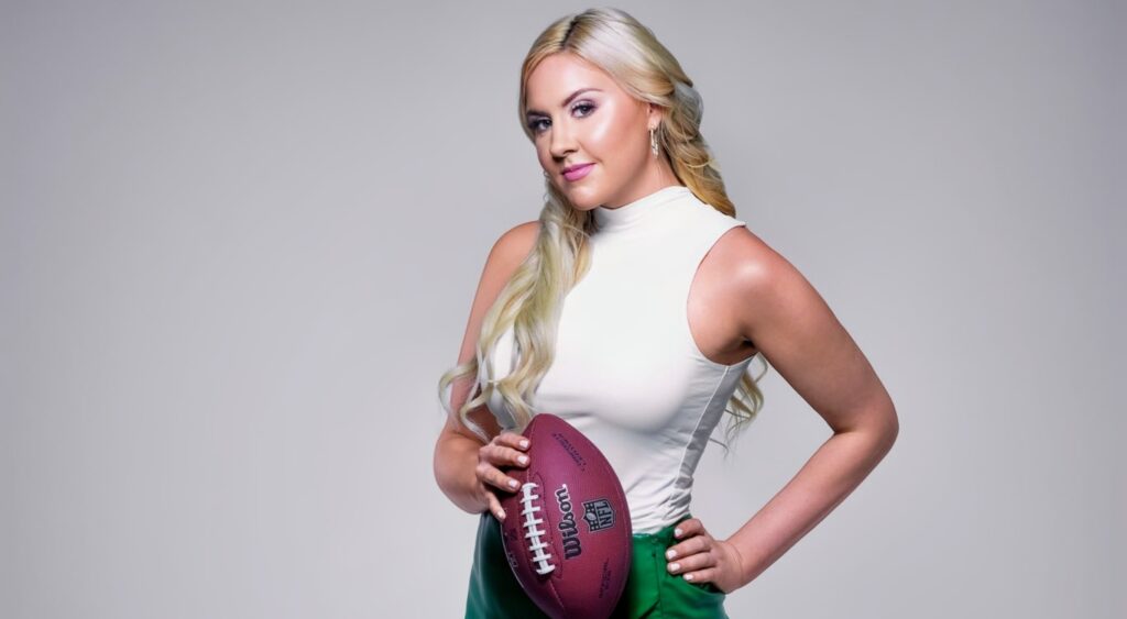 Crissy Froyd posing with a football