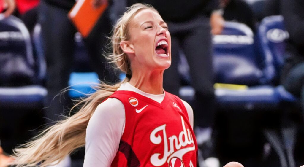 Indiana Fever guard Sophie Cunningham yelling while seated on the court