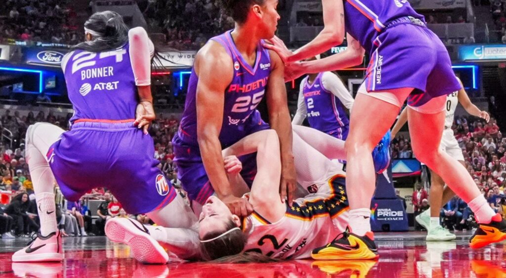 Phoenix Mercury forward Alyssa Thomas (25) scrambles to get up over Indiana Fever guard Caitlin Clark.