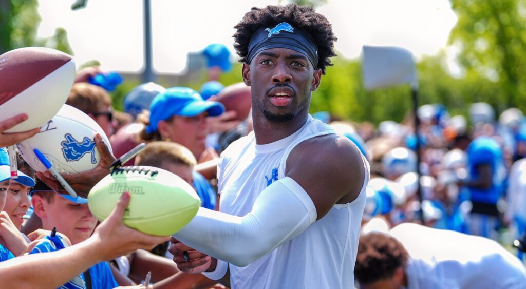 Detroit Lions CB Terrion Arnold signs autographs at the end of the joint practice.