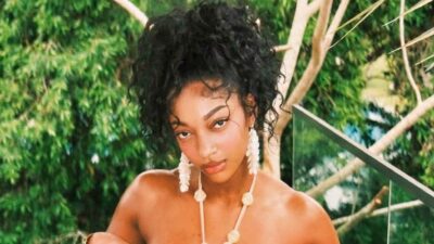 Angel Reese posing in a gold bikini