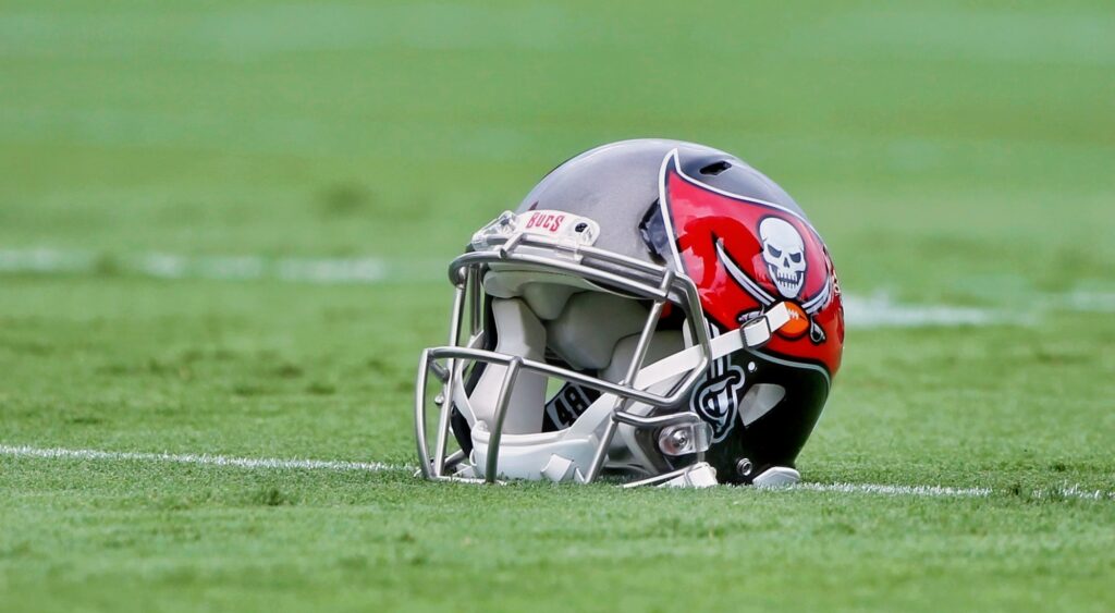 Tampa Bay Buccaneers helmet lays on the field.