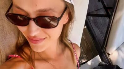 Mallory Edens posng in sunglasses and a bikini.