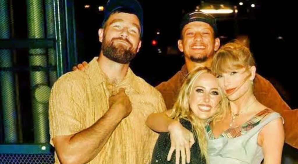 Travis Kelce, Patrick Mahomes, Taylor Swift, and Brittany Mahomes posing for a picture