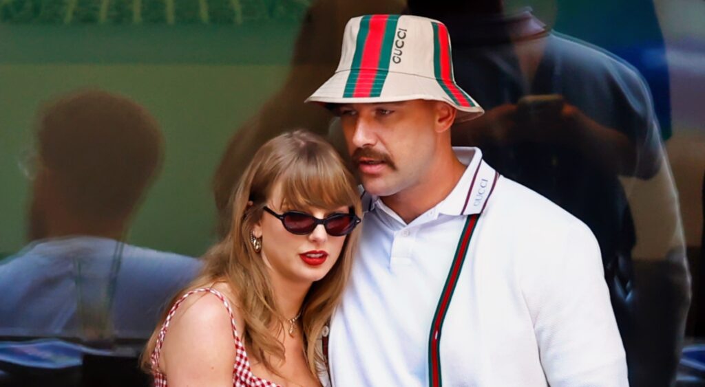 Taylor Swift and Travis Kelce hugging.