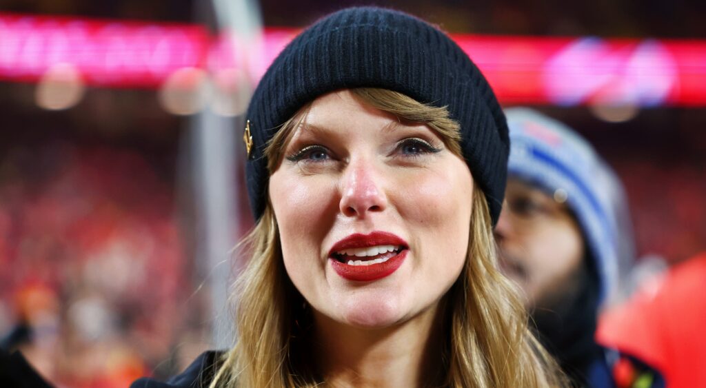 Recording artist Taylor Swift smiling while on the field.