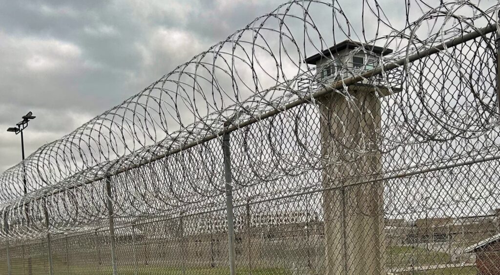 Prison fence and guard tower.