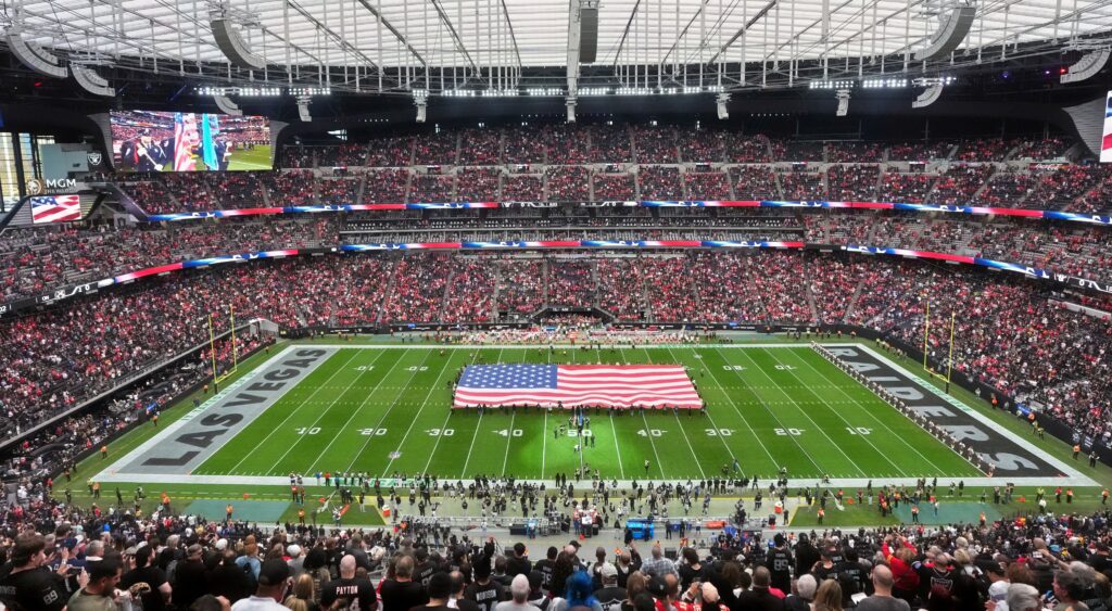 A general overall view of Allegiant Stadium with a United States flag on the field.