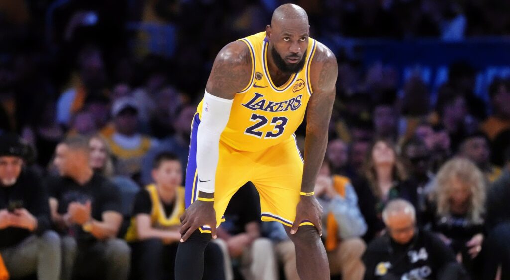 Los Angeles Lakers forward LeBron James with his hands on his knees.