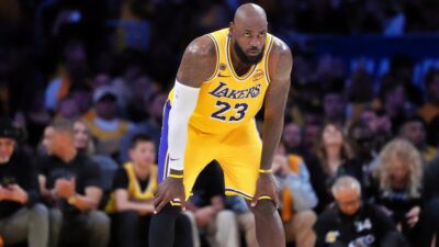 Los Angeles Lakers forward LeBron James with his hands on his knees.