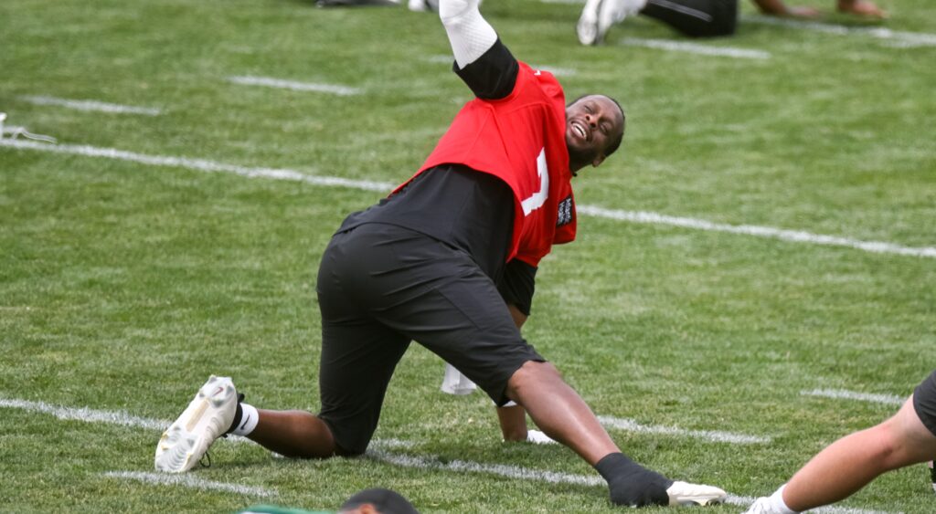 Geno Smith stretching at camp.