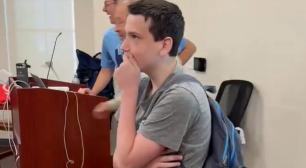 Young NFL fan covering his mouth