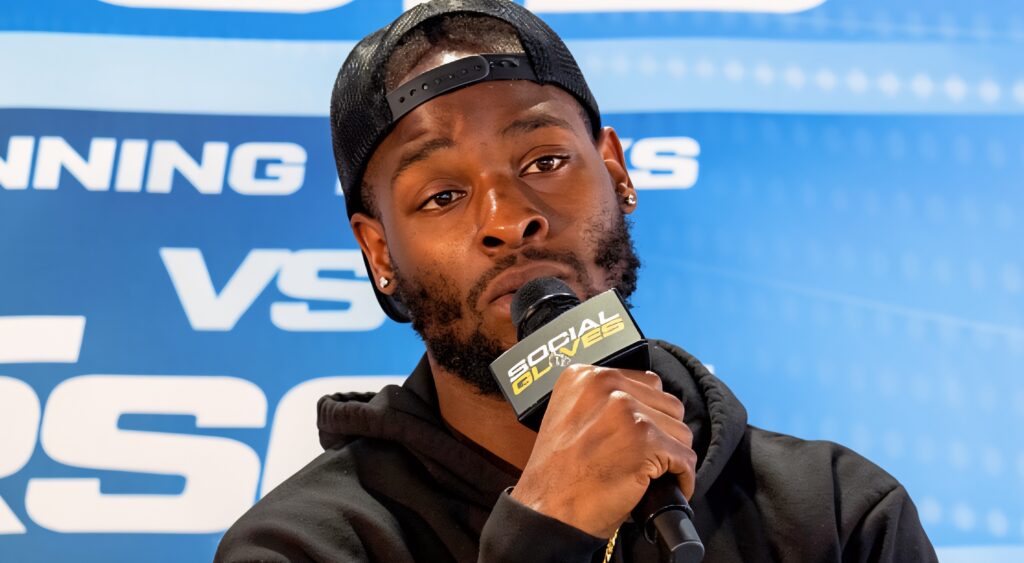 Le'Veon Bell speaking into mic