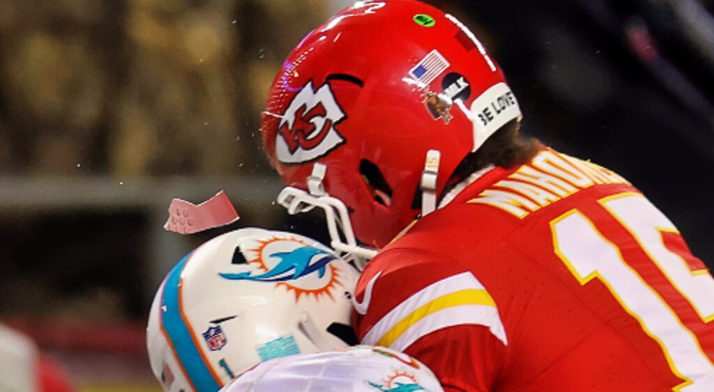 Safety DeShon Elliott #21 of the Miami Dolphins breaks the helmet of quarterback Patrick Mahomes as their helmets collide
